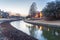 Riverside apartment building complex reflection at sunset