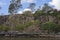 Riverside Boardwalk Against Steep Cliff Wall And Car Park