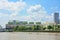 Riverside cooling towers emitting steam in electricity power plant with blue sky background, Bangkok Thailand