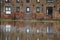 Riverside flats reflected in water at high tide.