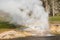 Riverside Geyser with a rainbow in Yellowstone, horizontal