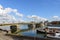 riverside of Meuse river, boat at pier and background of cityscape and Wilhelminabrug bridge in Maastricht, Netherlands.