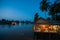 Riverside restaurant near Mekong River at twilight. Coconut trees silhouette, Beautiful lighting, restaurant and sunset sky