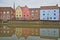 The riverside river Wensum with reflections of colorful houses and the tower and spire of the Cathedral