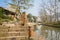 Riverside stone steps with iron chain handrail in small town