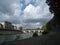 Riverside of Tevere with view on bridge and sky with white clouds