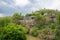 Riverside tile-roofed buildings on cliff in cloudy spirng afternoon