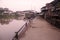 Riverside with wooden boat and house in thai countryside style