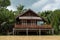 riverside wooden Thai house with plam farm