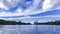 Riversides, speedboat and floating summer clouds 4K wide time lapse