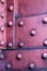 Rivets on red painted iron plates