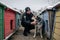 RIVNE, UKRAINE - DECEMBER 02, 2022. Police officer and homeless dog. Ukrainian female police officer takes care of stray dogs