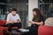 RIVNE, UKRAINE - JULY 14, 2023. People at business training. Confident woman and man sitting with phones at a meeting during a