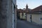 Rivoli old historical city centre, cobble stoned street and bell tower. Piedmont, Italy.