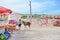 Rizokarpaso, Dipkarpaz, Turkish Northern Cyprus - Oct 3rd 2019: Caucasian woman standing on a street next to wild donkey