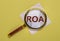 ROA acronym, inscription through magnifying lens