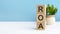 ROA - acronym from wooden blocks with letters, blue background. copy space available