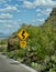 Road 15 mph sign warning of curves in the road ahead