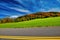 Road across New England countryside in foliage season, USA