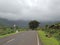 Road adjoining western Ghats of India- Monsoon season- lush greenery and cloud covered hills