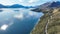 The road along the shoreline of lake Wakatipu and its surrounding mountain ranges