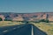 Road through Arizona landscape with large mesa