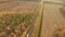 Road in the autumn forest aerial view with a passing truck.. Russia.