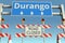 Road barricades near Durango city road sign. Lockdown in Mexico conceptual 3D rendering