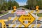 Road barriers and warning signs at entrance to a state campgound due to COVID-19 outbreak