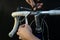 Road bike handlebars and dual control lever on a black background. Install handlebar tape white. Bicycle repair in a modern