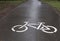 Road bike sign white on wet pavement. bike lane warning