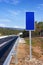 Road with blue sign pole