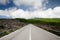 Road blue sky with clouds and green landscape