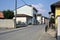 Road bordered by houses with a church at the end of it on a sunny day in a village in the italian countryside