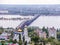 Road bridge across the Volga river between the cities of Saratov and Engels. The city`s skyline. An Orthodox Church. May