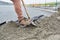 Road builder shovels concrete on a street