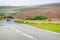 Road with car and sheep and mountains at Snowdonia UK