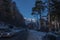 Road with cars in small city on background of snowy mountains. Romania, Sinaia