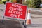 ROAD CLOSED ACCESS ONLY road sign with a traffic cone