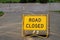 Road Closed sign over flooded road