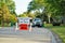 Road closed to thru traffic detour construction sign in a residential neighborhood