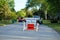 Road closed to thru traffic detour construction sign in a residential neighborhood