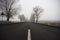 Road on a cold foggy winter\'s day