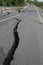 Road collapses with huge cracks. International road collapsed down after bad construction. Damaged Highway Road. Asphalt road.