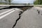 Road collapses with huge cracks. International road collapsed down after bad construction. Damaged Highway Road. Asphalt road.