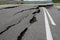 Road collapses with huge cracks. International road collapsed down after bad construction. Damaged Highway Road. Asphalt road.