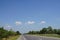 Road conditions, trees, roadside, sky, beautiful white clouds