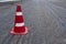 Road construction or repair - laying a new layer of asphalt, marking the level for increased accuracy and warning signs cone