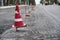 Road construction or repair - laying a new layer of asphalt, marking the level for increased accuracy and warning signs cone