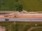 Road Construction Site near the highway with machinery, bulldozer, excavation from above. 4K video, top down view.